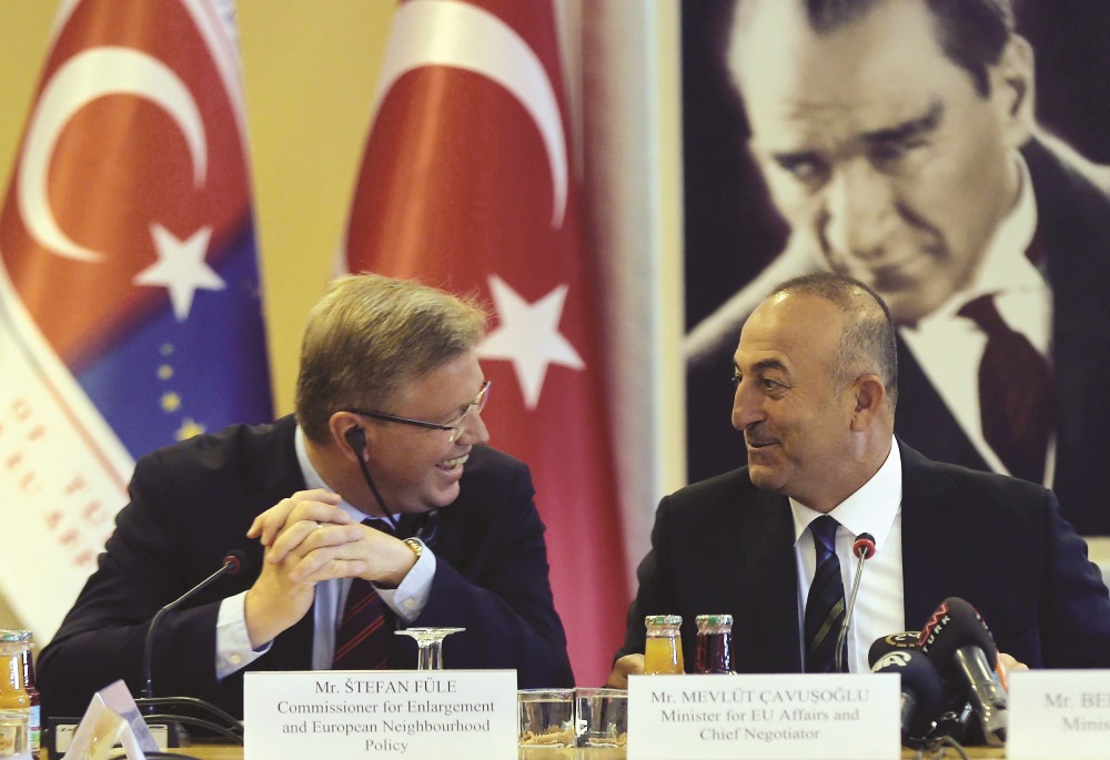 EU Enlargement Commissioner Stefan Fule and EU Minister - Chief Negotiator Mevlut Cavusoglu, appointed as the Foreign Minister, smile while taking part in a meeting of the working group on Chapter 23 of Turkey’s EU membership bid in Ankara, Turkey on June 17, 2014.  AFP / Adem Altan