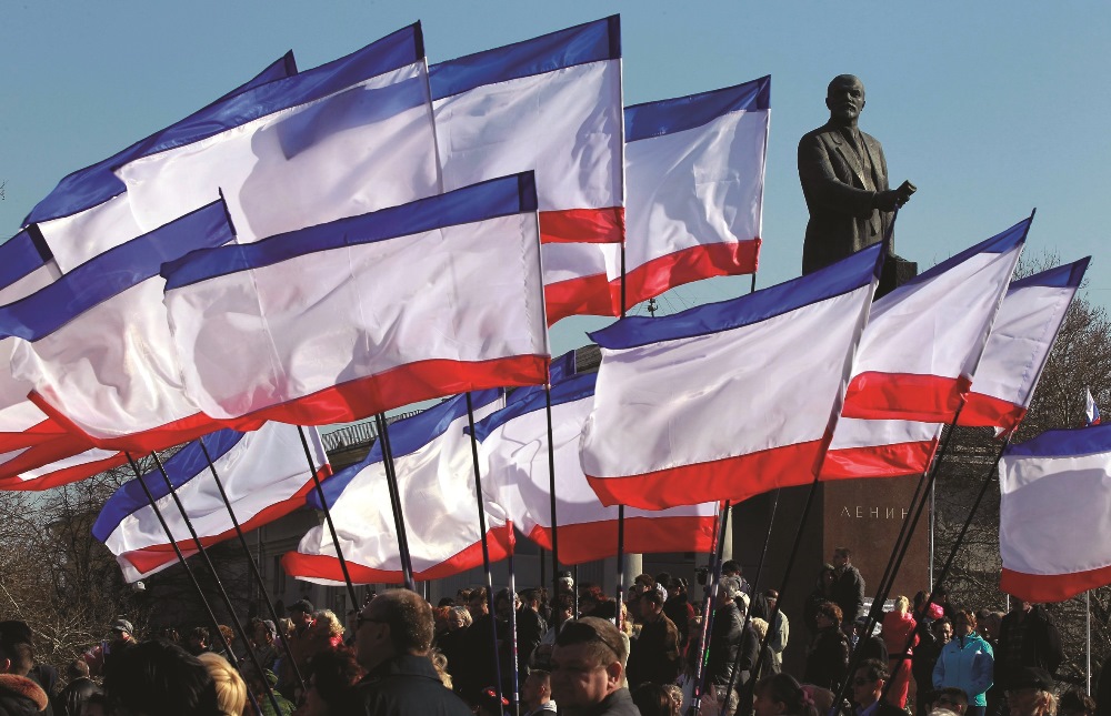 People attend a rally in front of Crimean flags at Lenin Square in Simferopol, Crimea, Ukraine, 15 March 2014.  EPA / Yuri Kochetkov